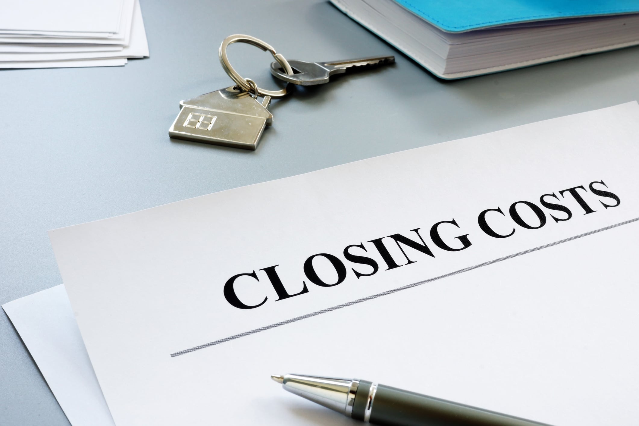 House keys and closing costs documents on a table | TruAssign