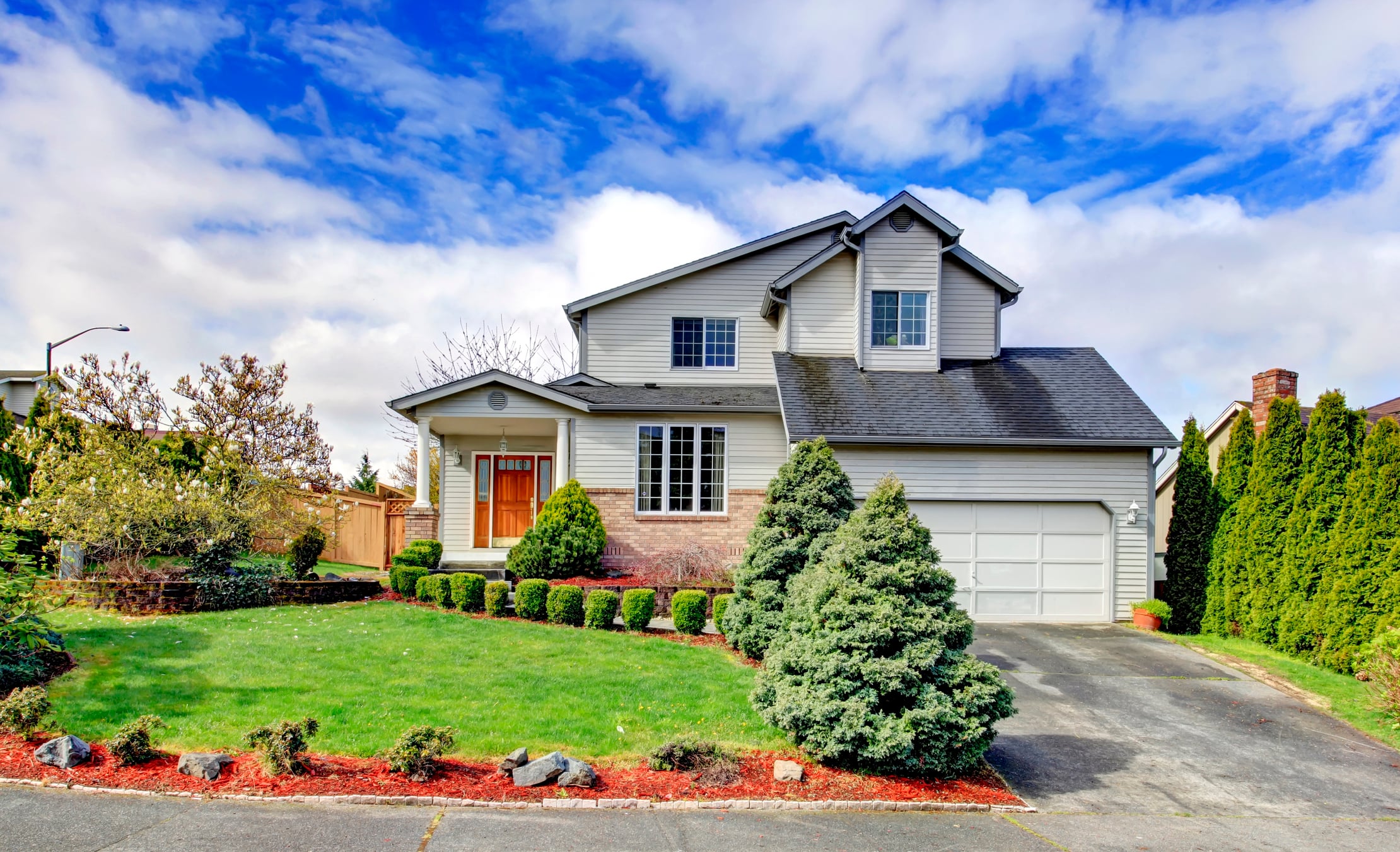 Suburban home exterior on a sunny day – example of a house that can be sold fast for cash